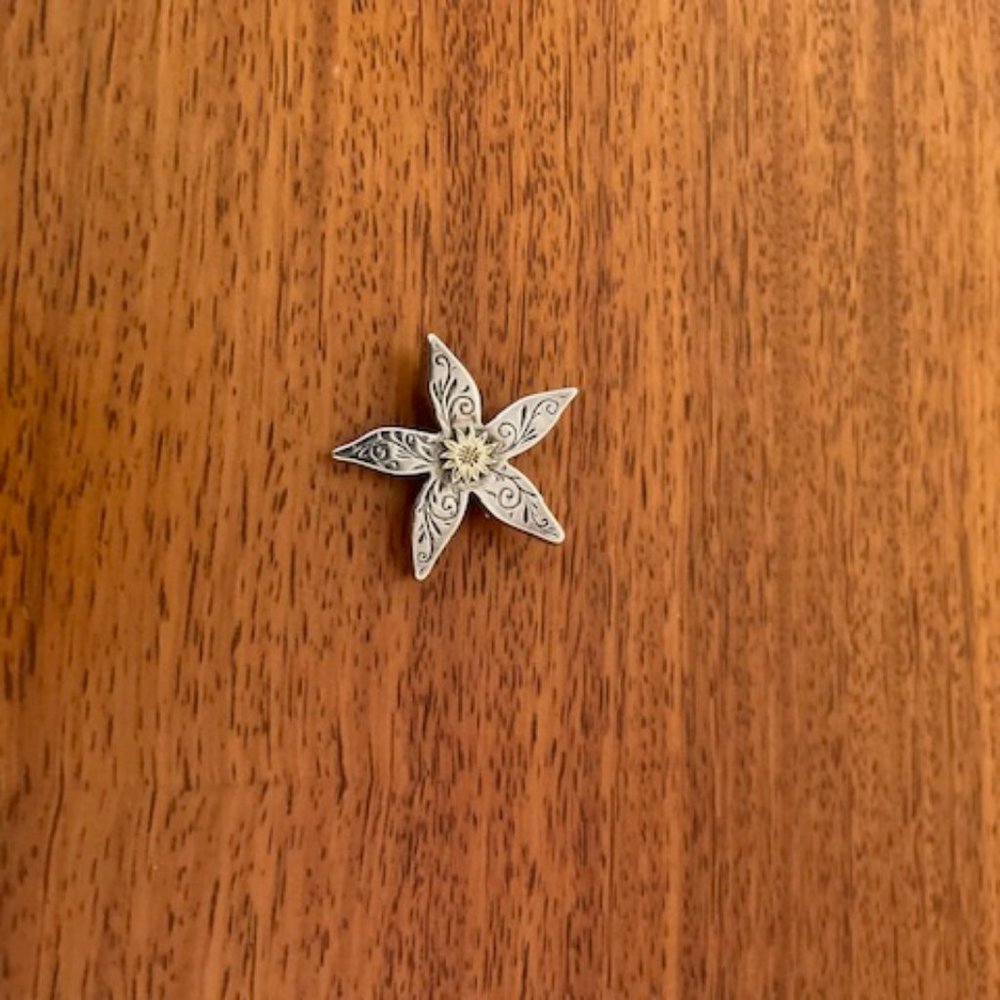 Silver floral brooch with gold accent